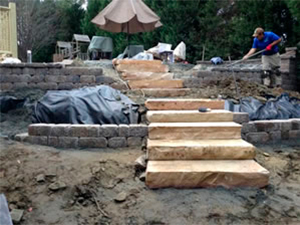 Construction in progress on the paver steps that lead up to the pool.