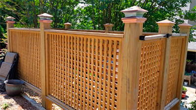 A beautiful looking wood lattice covering up the pool equipment.