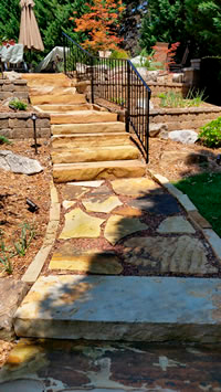 A flagstone walkway leading up to the pool area with some Flagstone steps. 