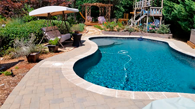 A final look at the pool area with a beautiful paver deck around it.
