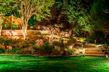 A nighttime look at the newly finished backyard with landscape lighting added.