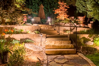 Another view of the steps leading to the pool area while they are illuminated by landscape lights.